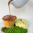 Steak and ale pie with mash and peas